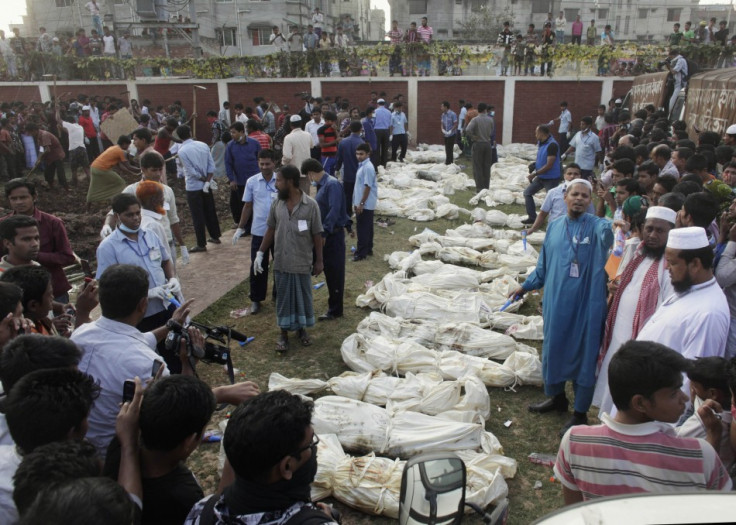 Bodies of unidentified garment workers, who died in fire in a garment factory, are lined up before a mass burial at a graveyard in Dhaka