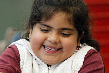 Maria Sandoval, a student in the Munroe Elementary School after-school garden club chops vegetables to put in a stir fry dish she would help cook in Denver