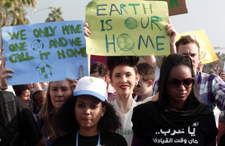 Activists march to demand action to address climate change in Doha