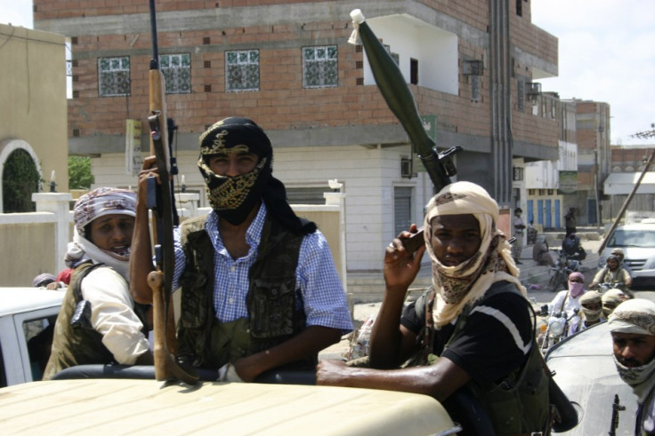 Members of Ansar al-Sharia, an al Qaeda-affiliated group, carry their weapons as they ride on a truck in Jaar