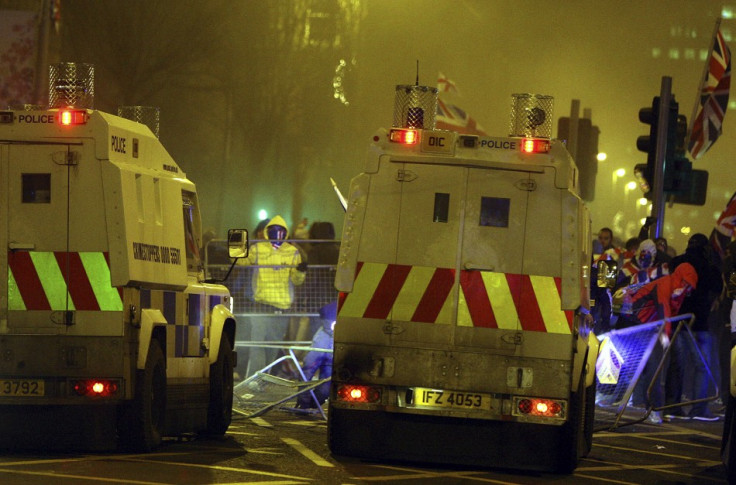 Loyalists clash with police officers outside the City Hall in Belfast (Reuters)