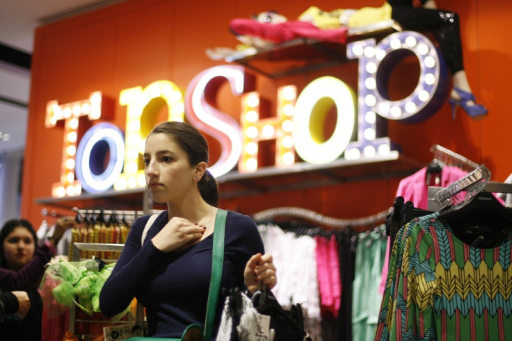 A woman looks at clothing items while shopping in the new Topshop and Topman clothing store in New York (Photo: Reuters)