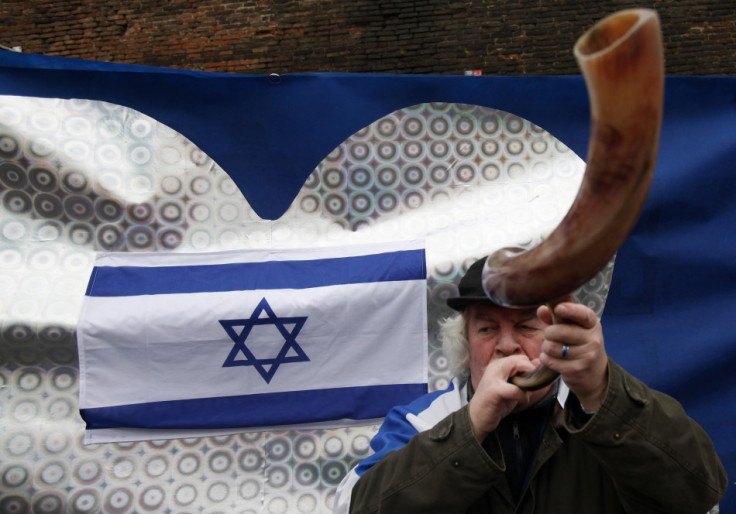 Israeli supporter blows a horn in front of Czech government headquarters in Prague