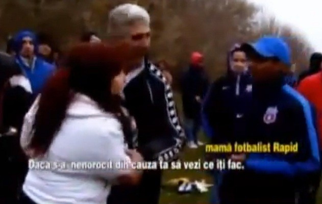 Let me at him: Angry mum is restrained by officials