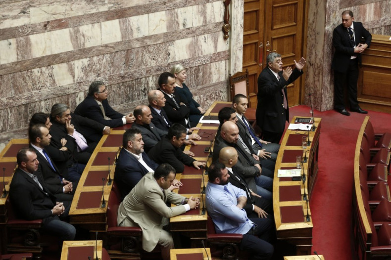 Leader of the extreme-right Golden Dawn party Mihaloliakos addresses parliamentarians during a parliament session