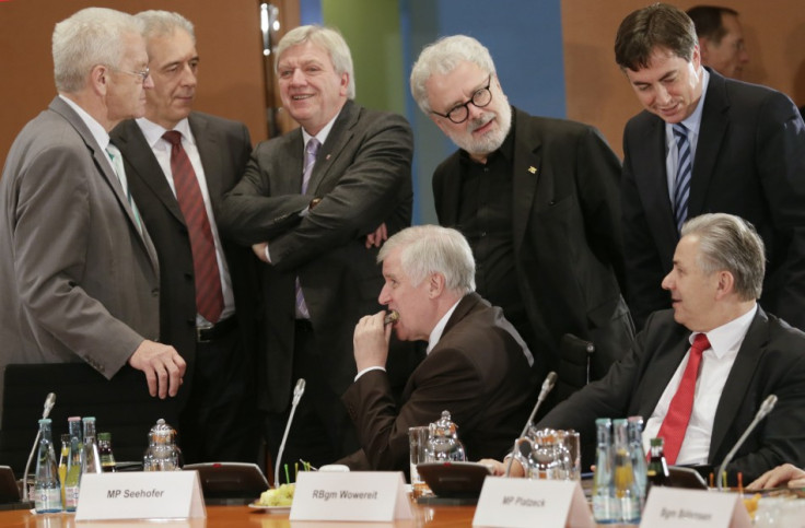 Bavarian state premier Seehofer eats a piece of cake before a meeting of federal state premiers with Chancellor Merkel
