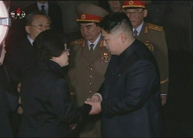 Kim Jung Un, flanked by generals, meets a subject Kim Jung Un, flanked by generals, meets a subject