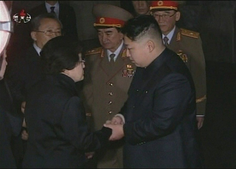 Kim Jung Un, flanked by generals, meets a subject