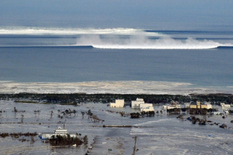 An oncoming tsunami strikes the coast in Natori City, Miyagi Prefecture
