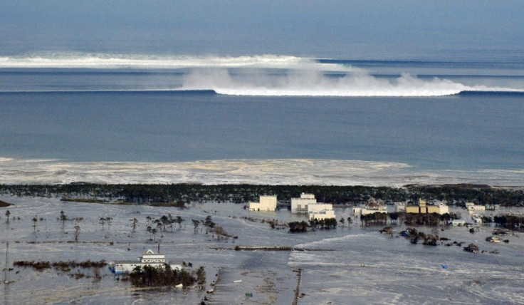 An oncoming tsunami strikes the coast in Natori City, Miyagi Prefecture