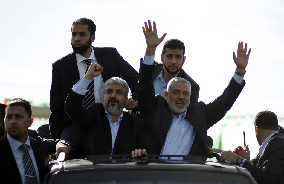 Hamas chief Khaled Meshaal and senior Hamas leader Ismail Haniyeh wave to the crowd upon Meshaals arrival in the southern Gaza Strip
