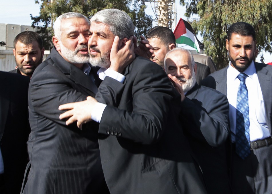Senior Hamas leader Ismail Haniyeh kisses Hamas chief Khaled Meshaal upon Meshaals arrival at the Rafah crossing in the southern Gaza Strip