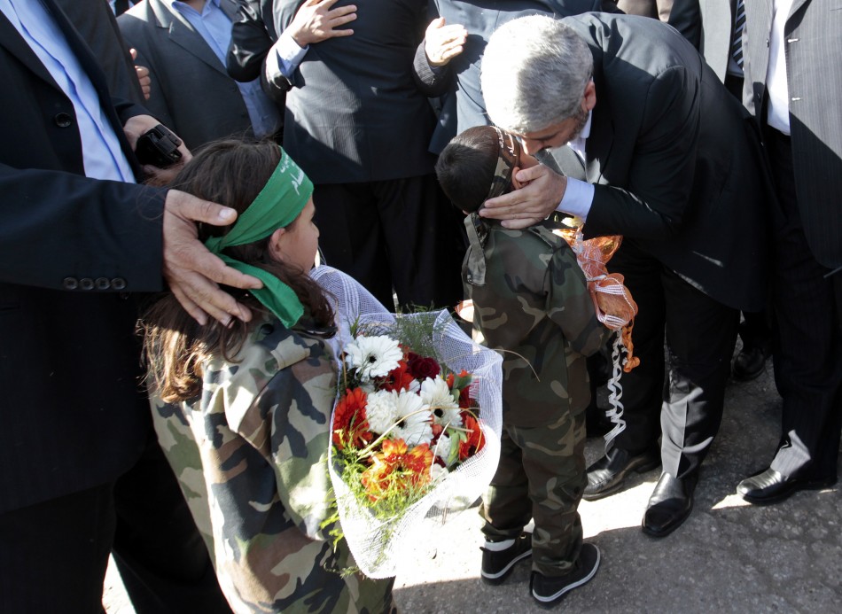 Hamas chief Khaled Meshaal kisses a Palestinian boy upon his arrival at the Rafah crossing in the southern Gaza Strip