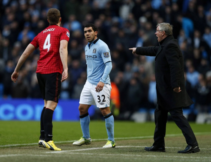 Phil Jones (L) and Carlos Tevez