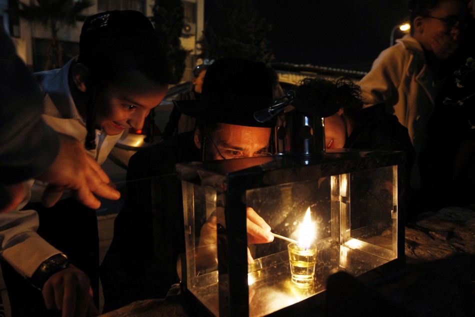 Ultra-Orthodox Jews light a candle for Hanukkah in Ashdod