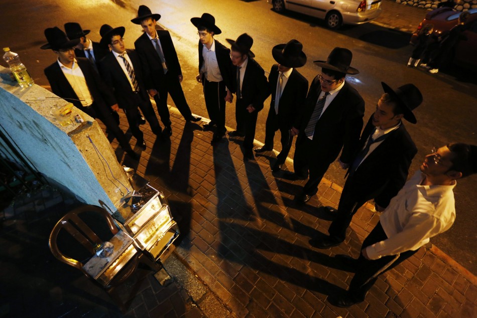 Ultra-Orthodox Jews dance after lighting candles for Hanukkah in Ashdod