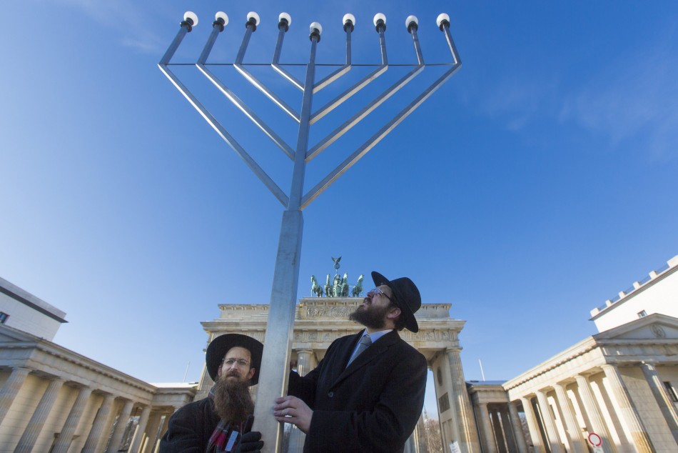 Rabbis Segal and Teichtal of Orthodox Jewish Chabad Lubawitsch community bless menorah after erecting it in front of Brandenburg Gate in Berlin ahead of Hanukkah celebrations