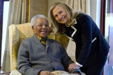 U.S. Secretary of State Hillary Rodham Clinton poses for a photograph with Nelson Mandela,