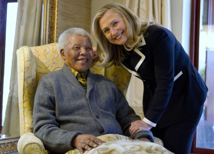 U.S. Secretary of State Hillary Rodham Clinton poses for a photograph with Nelson Mandela,