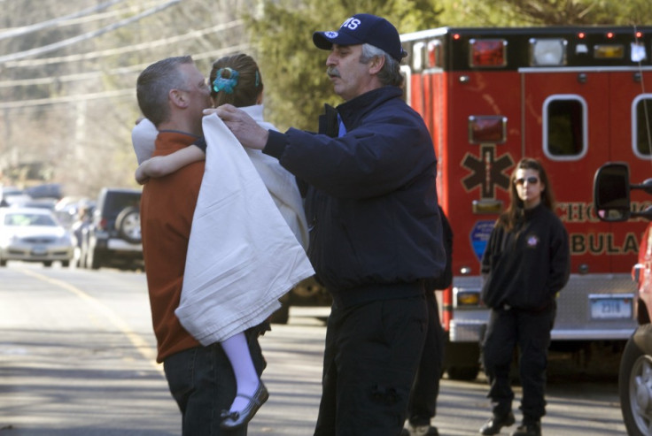 A Sandy Hook pupils is carried to safety after the massacre