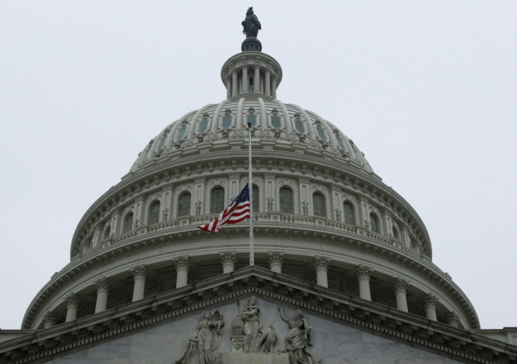 The United States flag flies at half staff in front of the U.S. Capitol dome in Washington