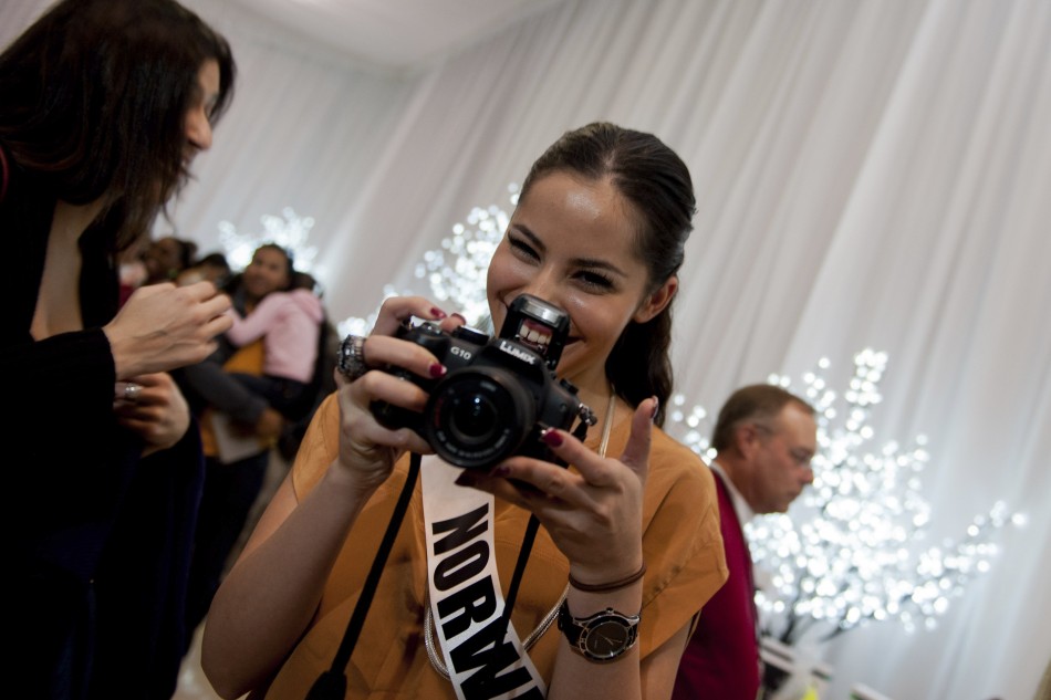 Miss Norway Andersen poses with a camera during the Miss Universe National Gift Auction in Las Vegas