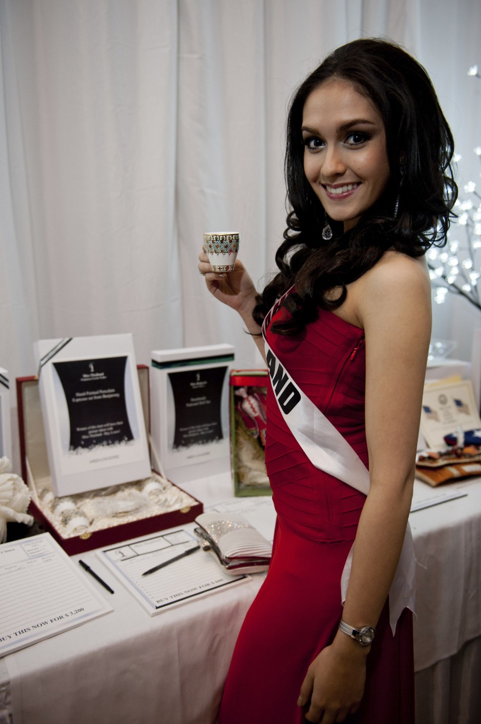 Miss Thailand Waller poses with her gift during the Miss Universe National Gift Auction in Las Vegas