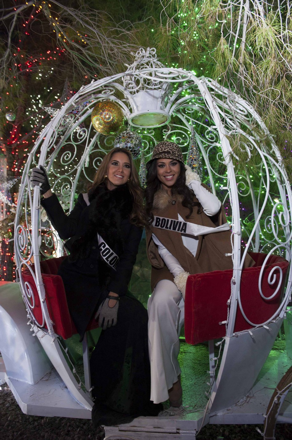 Miss Colombia Vasquez and Miss Bolivia Mouton pose during the Miss Universe National Gift Auction in Las Vegas