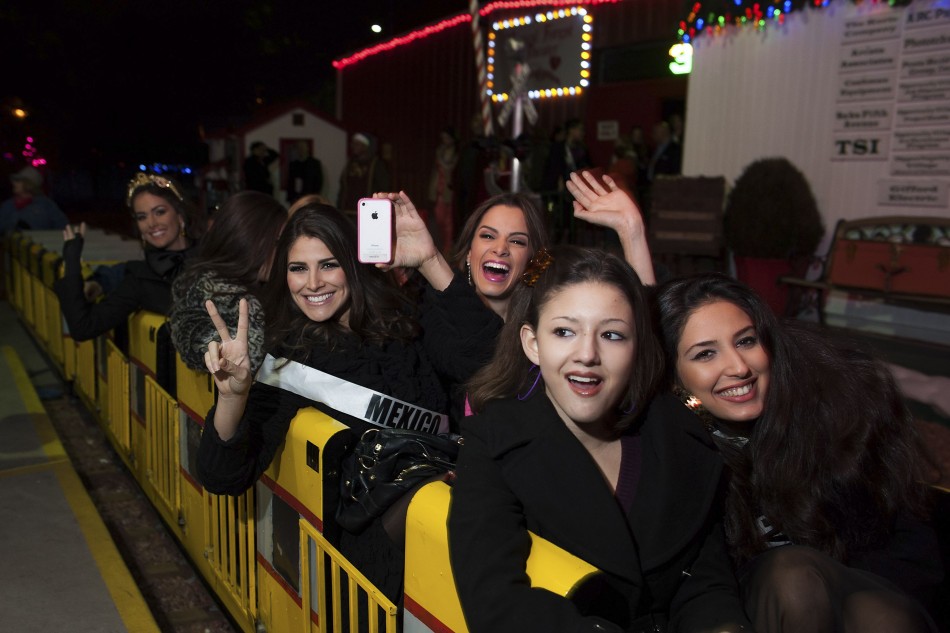 Miss Cyprus Yiannakou, Miss Mexico Gonzalez, Miss Guatemala Godoy and Miss Venezuela Quintero pose in a train during the Miss Universe National Gift Auction in Las Vegas