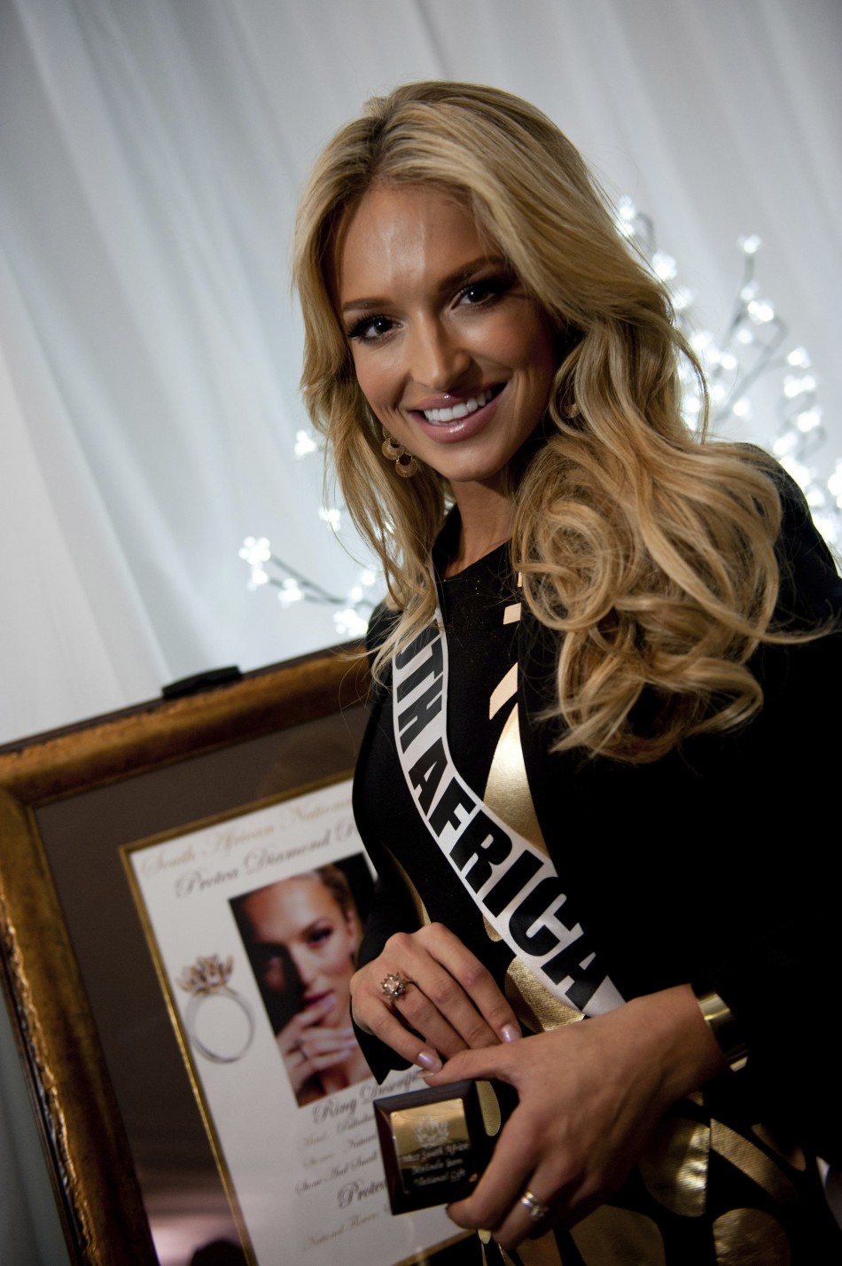 Miss South Africa Bam poses with her gift during the Miss Universe National Gift Auction in Las Vegas