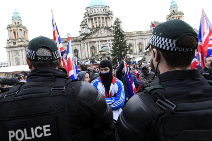 Protestors wave Union Flags and block the road in front of Belfast City Hall (Reuter