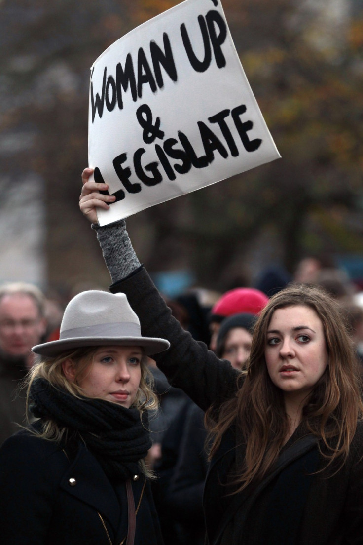 A woman holds a poster during a vigil in Dublin in memory of Savita Halappanavar