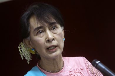 Myanmar pro-democracy Leader Aung San Suu Kyi talks to reporters during a news conference in Yangon
