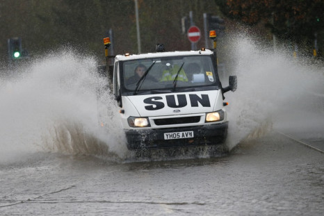 A van drives through a flooded street in Tewkesbury, south western England (Reuters)