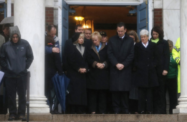 Connecticut Governor Daniel Malloy stands with others on the steps of the Edmond Town Hall during a moment of silence in Newtown (Reuters)