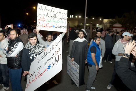 Demonstrators carry placards during a protest in Kuwait City
