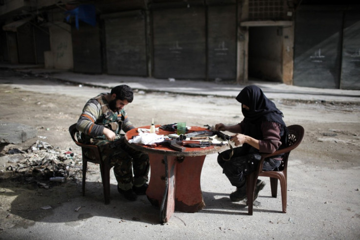 Fighters from the Islamist Syrian rebel group Jabhat al-Nusra clean their weapons in Aleppo