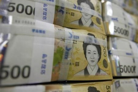 Fifty-thousand-won notes are piled up after being counted at a bank during a photo opportunity in Seoul