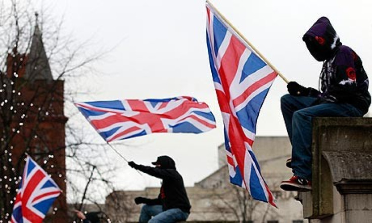 Protestors wave union flags in front of Belfast City Hall (Reuters)