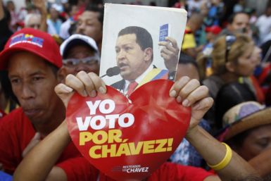 A supporter of Venezuela's President Chavez holds up a picture of him during the inauguration of the National Assembly in Caracas