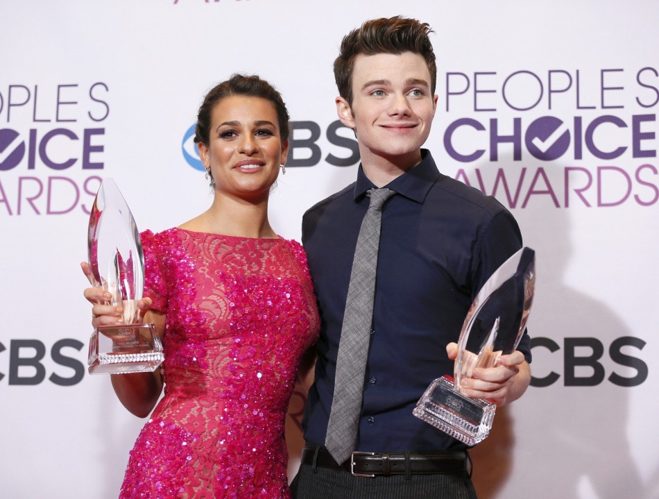 Actors Lea Michele and Chris Colfer hold their awards backstage at the 2013 Peoples Choice Awards in Los Angeles
