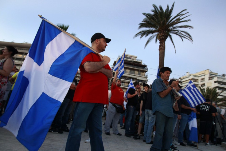 Supporters of the extreme right Golden Dawn party hold Greek flags