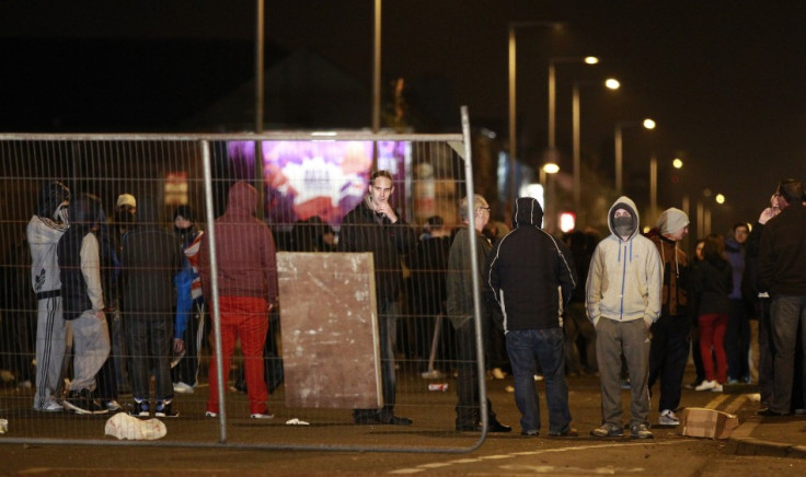 Youths place barricades across the Newtownards Road in Belfast during ongoing Union Flag protests in the city (Reuters)
