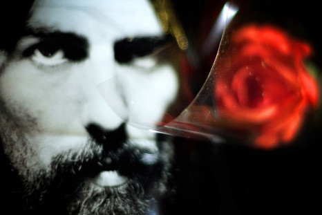 Floral tribute next to picture of Harrison