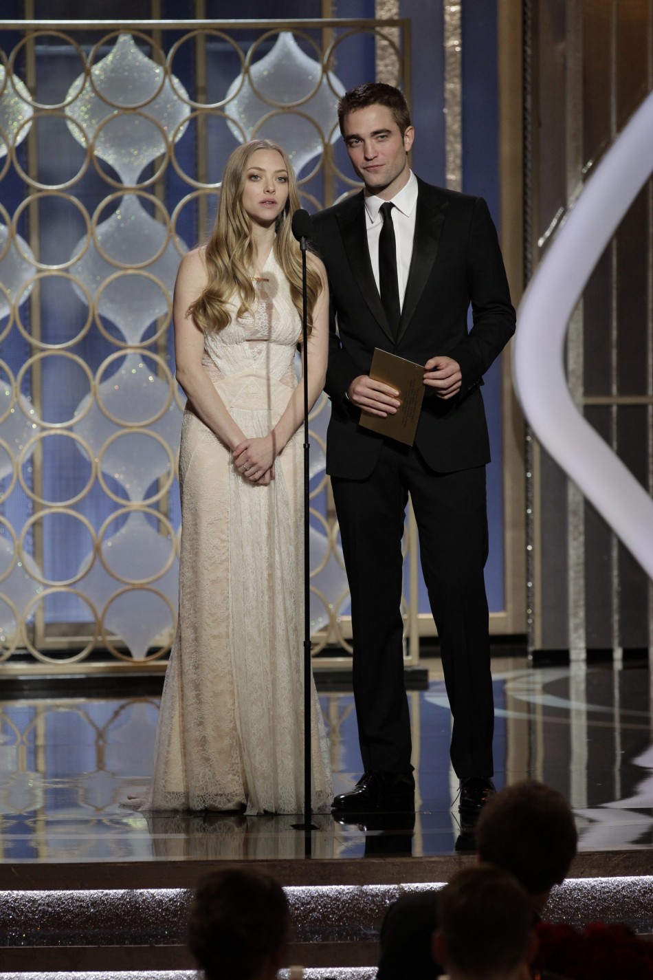 Presenters Amanda Seyfried and Robert Pattinson on stage at the Golden Globe Awards in Beverly Hills