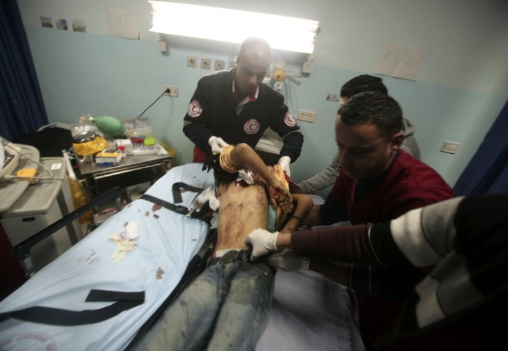 Palestinian medic lifts a Palestinian youth at a hospital in Ramallah