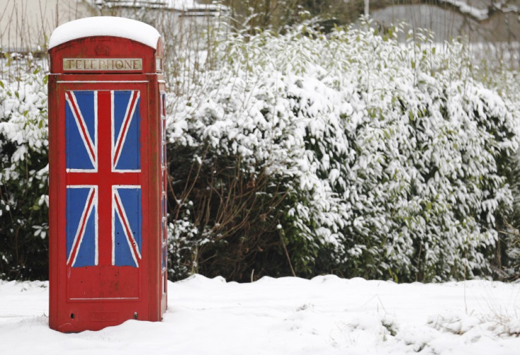 An old telephone box painted with the Union Flag stands out in the snow at Staplefield in south east England
