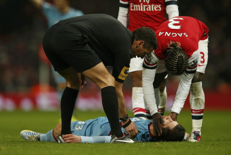 Andre Marriner and Bacary Sagna Check on Dan Potts