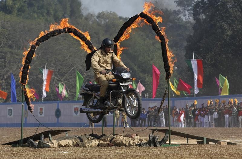 An Indian paramilitary trooper performs a stunt on his motorcycle during the Republic Day parade in Agartala, capital of northeast state Tripura, January 26, 2013.