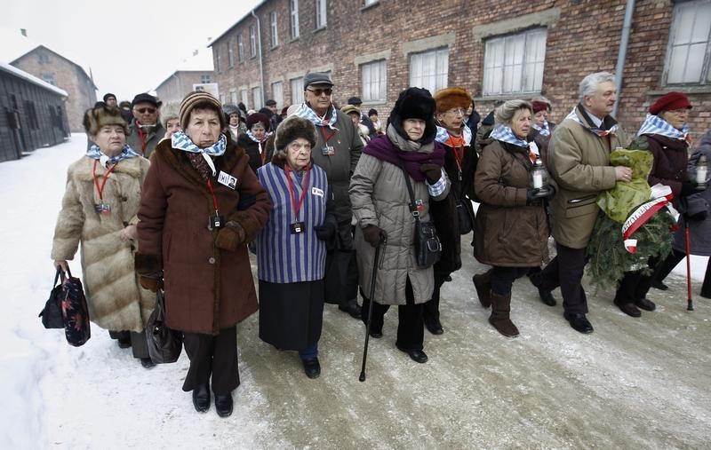 Former prisoners arrive to lay wreaths and flowers at the death wall of the Auschwitz concentration camp on January 27, 2013 during a ceremony marking the 68th anniversary of the camps liberation by Soviet troops and to remember the victims of the H